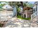 Landscaped backyard featuring playhouse, manicured lawn, and private driveway at 1021 Barfield St, Charleston, SC 29492