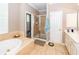 Large primary bathroom features a soaking tub, walk-in shower, and tile flooring at 1021 Barfield St, Charleston, SC 29492