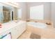 Large primary bathroom features a soaking tub, walk-in shower, and double vanity at 1021 Barfield St, Charleston, SC 29492