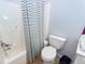 Bathroom features a shower with a striped curtain, toilet, and neutral wall color at 1021 Barfield St, Charleston, SC 29492