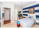 Bright bedroom with blue and white stripes, featuring a desk and nautical themed decor at 1021 Barfield St, Charleston, SC 29492
