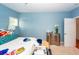 Bedroom with blue walls, bright light, a modern dresser, and a cluttered bed at 1021 Barfield St, Charleston, SC 29492