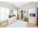 Bright bedroom with white dresser, neutral walls and carpet, and natural light from the shuttered windows at 1021 Barfield St, Charleston, SC 29492