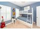 Stylized bedroom with a bunk bed, neutral walls, and window with plantation shutters at 1021 Barfield St, Charleston, SC 29492