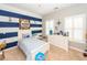 Nautical themed bedroom with blue stripes, white furniture, and natural light from the shuttered windows at 1021 Barfield St, Charleston, SC 29492