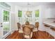 Cozy breakfast nook features a round table with seating for four next to a door leading to the outside at 1021 Barfield St, Charleston, SC 29492