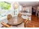 Sunlit breakfast nook shows a round table with seating and connects to an open kitchen with counter seating at 1021 Barfield St, Charleston, SC 29492