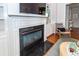 Living room fireplace with white trim, marble surround, built-in shelving, and hardwood flooring at 1021 Barfield St, Charleston, SC 29492