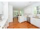 Bright open kitchen features white cabinets, island countertop seating and is connected to the breakfast nook at 1021 Barfield St, Charleston, SC 29492