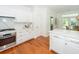 Bright and modern kitchen featuring white cabinets, stone countertops, and stainless steel appliances and fixtures at 1021 Barfield St, Charleston, SC 29492
