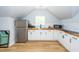 Bright kitchenette features white cabinets, butcher block countertops, and stainless steel appliances at 1021 Barfield St, Charleston, SC 29492
