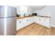 Well-lit kitchenette with white cabinets, butcher block countertops, and stainless steel appliances at 1021 Barfield St, Charleston, SC 29492