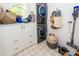 Laundry room featuring a stackable washer and dryer, white cabinets, tile flooring and shiplap walls at 1021 Barfield St, Charleston, SC 29492