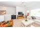 Bright living room features a comfortable white sofa, ceiling fan, and mounted tv at 1021 Barfield St, Charleston, SC 29492