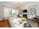 Bright living room with a fireplace, decorative chandelier, neutral walls and furniture, and hardwood flooring at 1021 Barfield St, Charleston, SC 29492