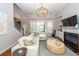 Bright living room with a fireplace, decorative chandelier, neutral walls and furniture, and a view of a waterfront at 1021 Barfield St, Charleston, SC 29492