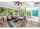 Relaxing screened patio with comfortable seating, ceiling fan, and outdoor view at 1021 Barfield St, Charleston, SC 29492