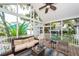 Relaxing screened patio with comfortable seating, ceiling fan, and backyard view at 1021 Barfield St, Charleston, SC 29492