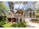 Spacious backyard with a custom-built treehouse and steps to the house, perfect for  at 1021 Barfield St, Charleston, SC 29492