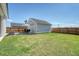 Spacious backyard with green grass, a detached garage, and outdoor seating area at 106 Wood Sage Run, Summerville, SC 29485