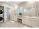 Bright bathroom with double vanity, linen closet, tiled shower, and tile flooring at 106 Wood Sage Run, Summerville, SC 29485