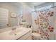 Bright bathroom with a single sink vanity and a shower with a decorative curtain at 106 Wood Sage Run, Summerville, SC 29485