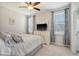 Bright bedroom with a large bed, dresser, and two windows with blinds at 106 Wood Sage Run, Summerville, SC 29485