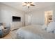 Spacious bedroom featuring wood floors, ceiling fan, and an ensuite bathroom at 106 Wood Sage Run, Summerville, SC 29485