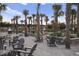 Charming common area featuring Adirondack chairs, palm trees and views of nearby homes at 106 Wood Sage Run, Summerville, SC 29485