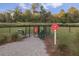 Fully-fenced dog park with gated entry, picnic table, and waste station at 106 Wood Sage Run, Summerville, SC 29485