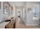Welcoming entryway with wood-look flooring, console table, and decorative art at 106 Wood Sage Run, Summerville, SC 29485
