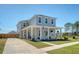 Attractive two-story home with a welcoming covered front porch, complemented by a well-manicured lawn and driveway at 106 Wood Sage Run, Summerville, SC 29485