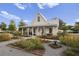 Charming home with white siding, metal roof, front porch and landscaped yard at 106 Wood Sage Run, Summerville, SC 29485