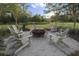 Cozy outdoor fire pit area surrounded by Adirondack chairs at 106 Wood Sage Run, Summerville, SC 29485