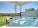 Close up of backyard hot tub with cover open and filled with clear water at 106 Wood Sage Run, Summerville, SC 29485