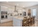 Modern kitchen with white cabinets, stainless steel appliances, a spacious island, and convenient seating at 106 Wood Sage Run, Summerville, SC 29485