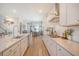 Bright, open kitchen with stainless appliances, white cabinetry, and long countertops perfect for gatherings at 106 Wood Sage Run, Summerville, SC 29485