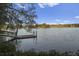 Picturesque lake view featuring a wooden dock and serene water at 106 Wood Sage Run, Summerville, SC 29485