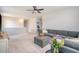 Open living room featuring a plush sectional sofa, ottoman, and ceiling fan at 106 Wood Sage Run, Summerville, SC 29485