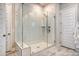 Glass enclosed walk-in shower features white subway tile, and marble floor at 106 Wood Sage Run, Summerville, SC 29485