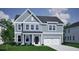 Charming two-story home with blue siding, white trim, a well-manicured lawn, and attached two-car garage at 117 Seaton St, Summerville, SC 29486