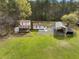 Aerial view of a property featuring a charming home with a deck and a large metal outbuilding at 117 Wernham Ln, Moncks Corner, SC 29461