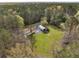 Aerial view of a home with a sprawling green lawn and a large metal outbuilding, surrounded by mature trees at 117 Wernham Ln, Moncks Corner, SC 29461