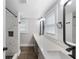 Modern bathroom with marble tile, glass shower, double sink, and updated fixtures at 117 Wernham Ln, Moncks Corner, SC 29461