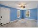 Bright bedroom with blue walls, ceiling fan, carpeted floors, and natural light at 117 Wernham Ln, Moncks Corner, SC 29461
