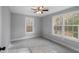 Bedroom with gray walls, carpeted floors, two windows, and ceiling fan at 117 Wernham Ln, Moncks Corner, SC 29461