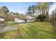 Exterior view of a two-story white home with a large front yard and surrounding trees at 117 Wernham Ln, Moncks Corner, SC 29461