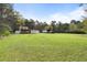 Sprawling backyard with a home, large barn, and lush greenery at 117 Wernham Ln, Moncks Corner, SC 29461