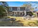 Charming backyard featuring a well-maintained lawn, patio, and mature trees offering shade and privacy at 125 Mansfield Blvd, North Charleston, SC 29418