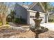 Features of the home's side exterior, including a fountain, walkway, and two-car garage at 125 Mansfield Blvd, North Charleston, SC 29418